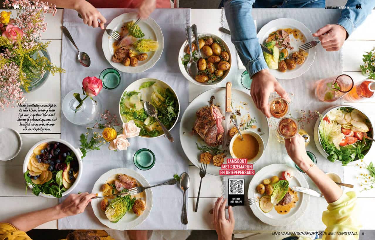 a spread from Delhaize's online catalog showing a dining table full of delicious recipes.