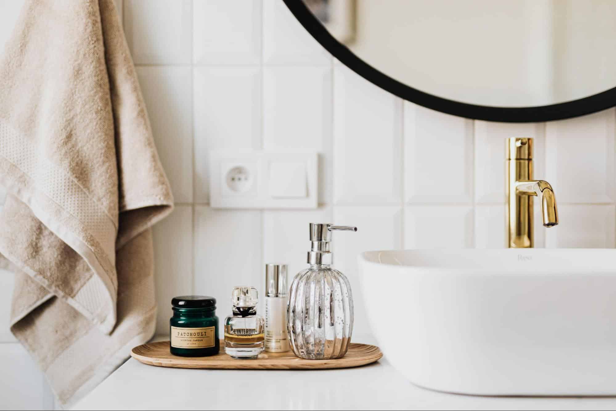 A collection of skin care products, a towel, and a sink.